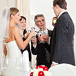 Program Items - Reinweiss Hochzeiten Wedding party clinking glasses, bride in white dress, elegant atmosphere.